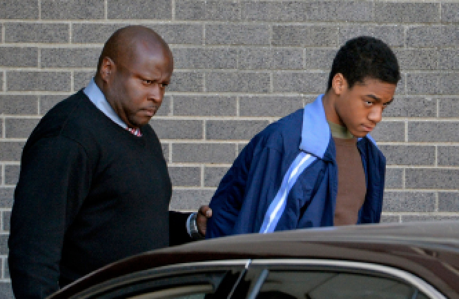 ANDERSON BEING ESCORTED TO HIS ARRAIGNMENT